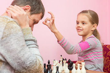 Image showing My daughter has a finger on the pope\'s head, who lost a game of chess