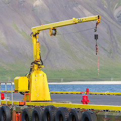 Image showing Fishing crane in small seaside Iceland town harbor