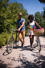 Image showing Young  couple having joyful bike ride in nature