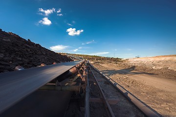 Image showing Long conveyor belt transporting ore