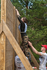 Image showing Sportsmen storm wall in extrim race. Tyumen