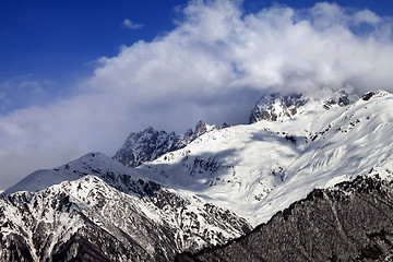 Image showing Snow mountains in clouds in winter sun day