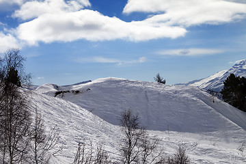 Image showing Off-piste slope with traces from skis and snowboards in sun day