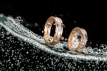 Image showing Golden Rings In The Water