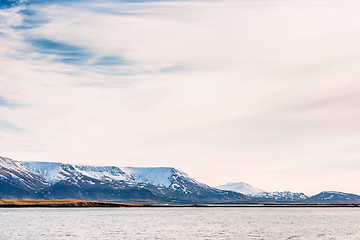 Image showing Snow covered mountains in the sea