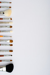 Image showing makeup brush and cosmetics, on a white background