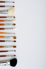 Image showing makeup brush and cosmetics, on a white background