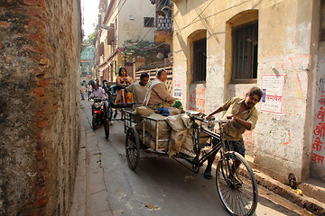 Image showing Rickshaw-puller carrying goods on the road of Kolkata