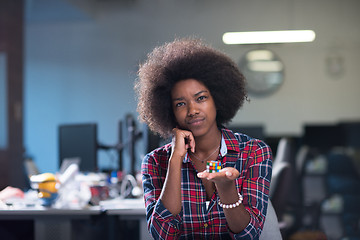 Image showing young black woman at her workplace in modern office  African-Ame