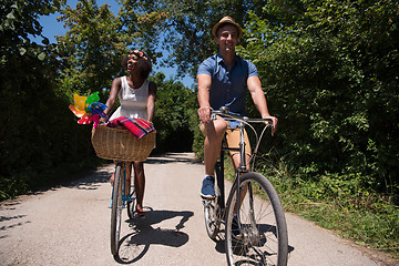 Image showing Young  couple having joyful bike ride in nature