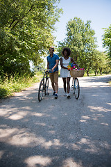 Image showing Young  couple having joyful bike ride in nature