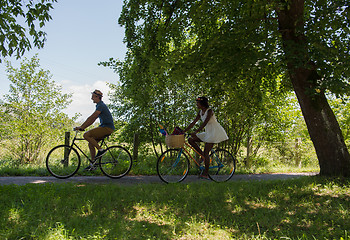 Image showing Young  couple having joyful bike ride in nature