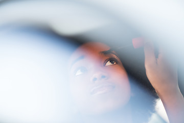 Image showing woman making makeup while driving car