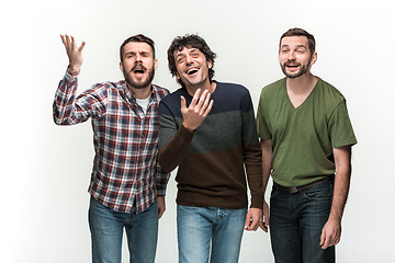 Image showing The three men are smiling, looking at camera