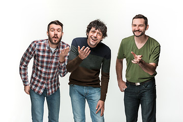 Image showing The three men are smiling, looking at camera