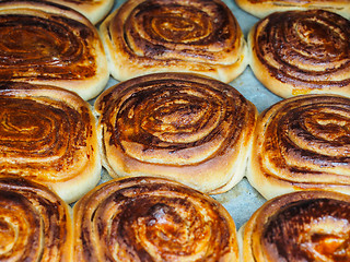 Image showing Closeup of fresh baked cinnamon buns after baking in oven, with 