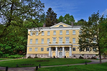 Image showing Yellow old manor with a garden