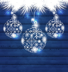 Image showing Christmas balls made in snowflakes on blue wooden background