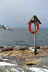 Image showing Lifebuoy on a rocky coast