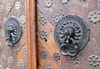 Image showing Iron lion knockers on a wooden door