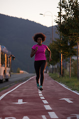 Image showing a young African American woman jogging outdoors