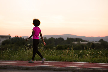 Image showing a young African American woman jogging outdoors