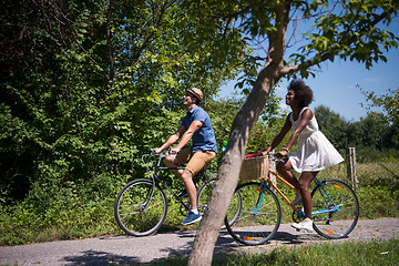 Image showing Young  couple having joyful bike ride in nature