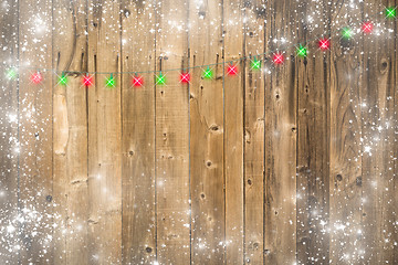 Image showing Wooden Background with Christmas Lights and Snowy Border