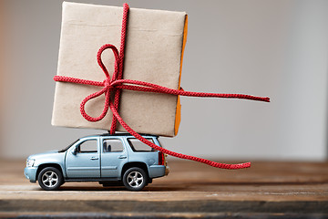 Image showing Postcard with car carrying gift