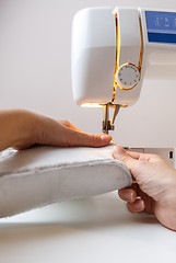 Image showing Sewing machine with girl close-up