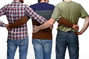 Image showing United friends of business men standing in embrace in background