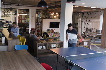 Image showing playing ping pong tennis at creative office space