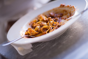 Image showing a young African American woman eating pasta