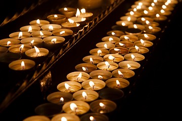 Image showing Candles in a dark church