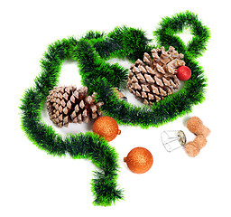 Image showing Green Christmas tinsel, Christmas-tree balls, pine cones and cha