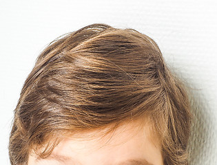 Image showing Closeup of a neet hairstyle on a young boy, towards a white wall