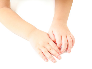 Image showing Toddler leaning towards on a white table, with hands together