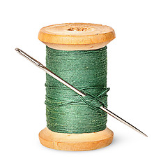 Image showing Needle and thread on wooden spool vertically