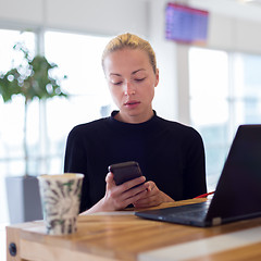 Image showing Female freelancer remotely working on the go.