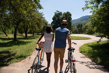 Image showing Young  couple having joyful bike ride in nature