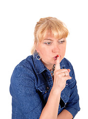 Image showing Closeup of blond woman with finger over mouth.