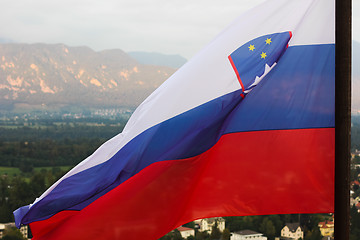 Image showing Slovenian national flag fluttering over Lake Bled