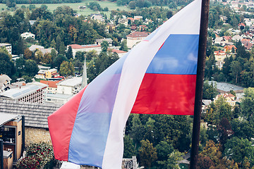 Image showing Slovenian national flag fluttering over Lake Bled