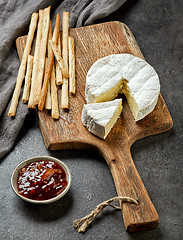 Image showing camembert cheese on wooden cutting board