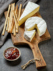 Image showing camembert cheese on wooden cutting board