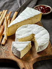 Image showing camembert cheese on wooden cutting board