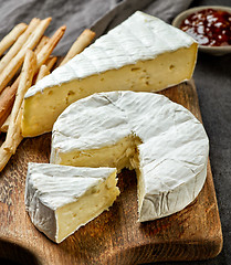 Image showing camembert cheese on wooden cutting board