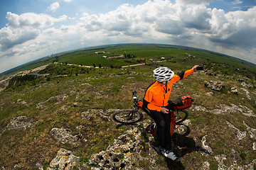 Image showing Cyclist taking picture with smart phone.