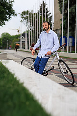 Image showing young hipster man with fixed gear bike on city street