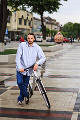 Image showing young hipster man with fixed gear bike on city street